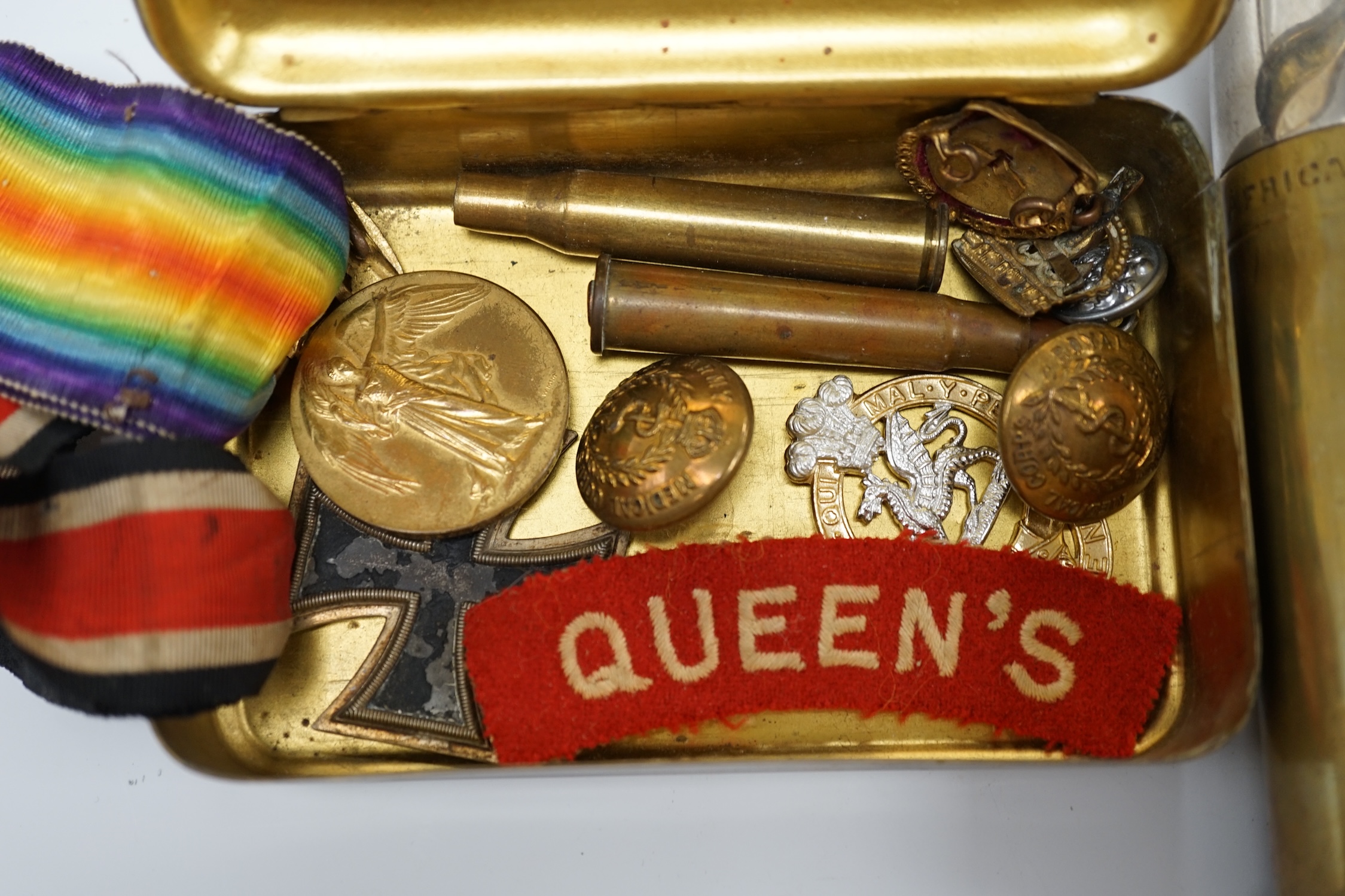 A collection of First World War memorabilia, including; a Victory Medal awarded to Gnr. W.R.P. Harris R.A., a Second Class Iron Cross, plus some buttons and badges contained within a Princess Mary Christmas tin, and a sh